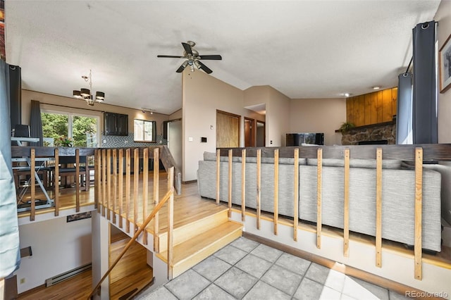 8386 S Davco Dr, Morrison, CO 80465 - stairway with a chandelier, ceiling fan, vaulted ceiling, and tile patterned flooring