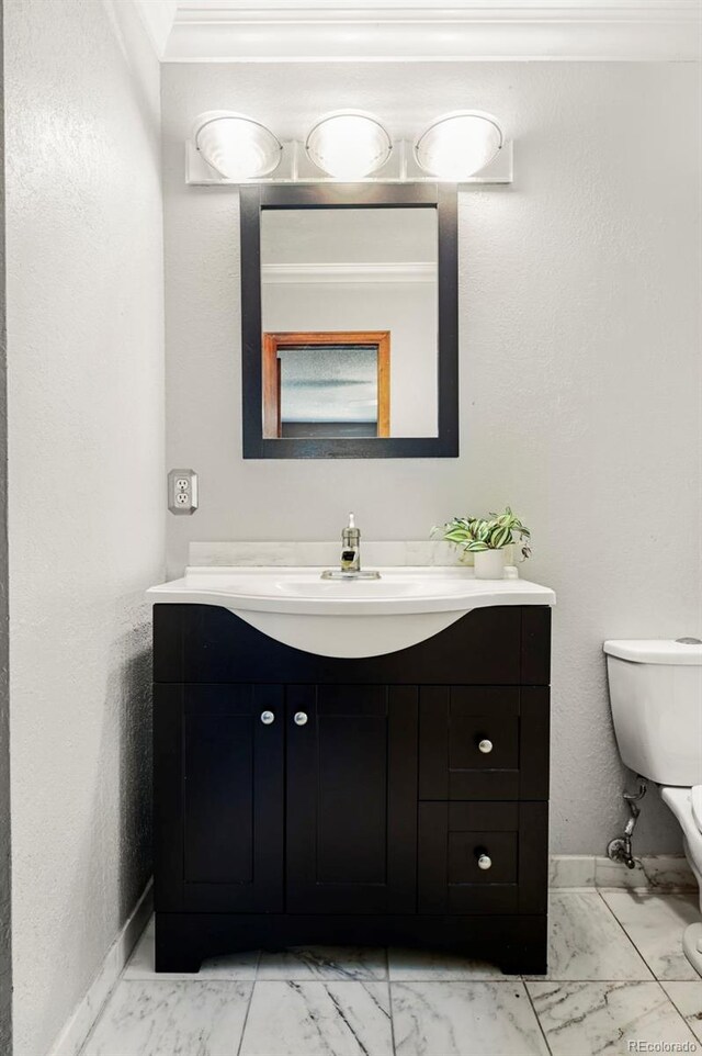8386 S Davco Dr, Morrison, CO 80465 - bathroom with vanity, marble finish floors, toilet, and baseboards