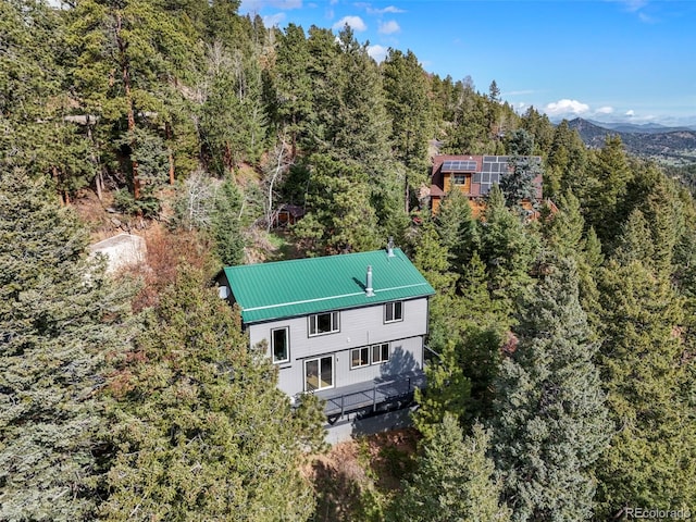 8386 S Davco Dr, Morrison, CO 80465 - view of subject property with a heavily wooded area and a mountainous background