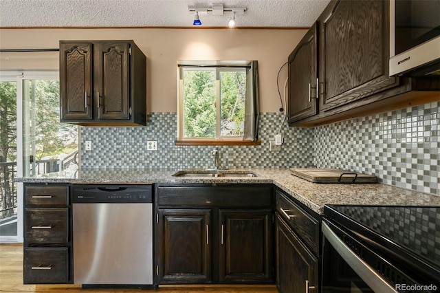 8386 S Davco Dr, Morrison, CO 80465 - kitchen with dishwasher, a sink, a textured ceiling, backsplash, and dark brown cabinetry