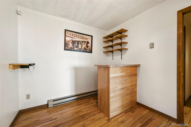 8386 S Davco Dr, Morrison, CO 80465 - bar with a baseboard heating unit, a textured ceiling, wood finished floors, and baseboards