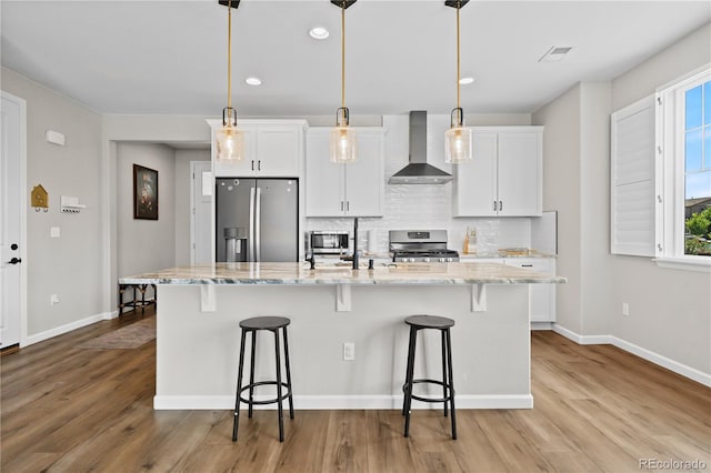 1925 Peregrine Dr, Brighton, CO 80601 - kitchen featuring stainless steel appliances, wall chimney exhaust hood, white cabinets, and recessed lighting