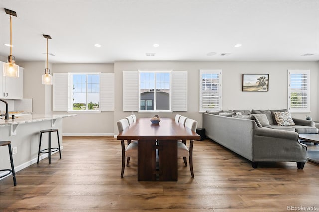 1925 Peregrine Dr, Brighton, CO 80601 - dining space featuring healthy amount of natural light, hardwood / wood-style flooring, and recessed lighting
