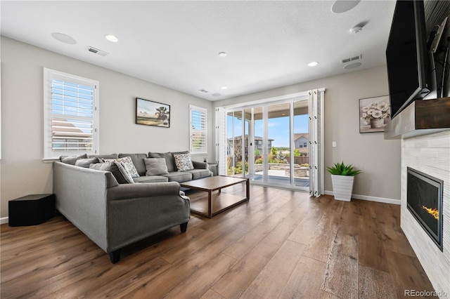 1925 Peregrine Dr, Brighton, CO 80601 - living room with wood finished floors, a fireplace, and recessed lighting