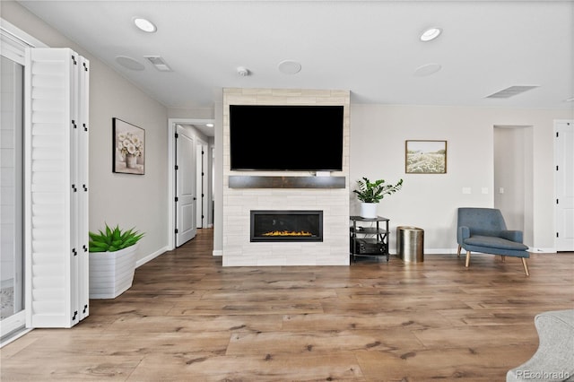 1925 Peregrine Dr, Brighton, CO 80601 - living area featuring wood finished floors, a large fireplace, and recessed lighting