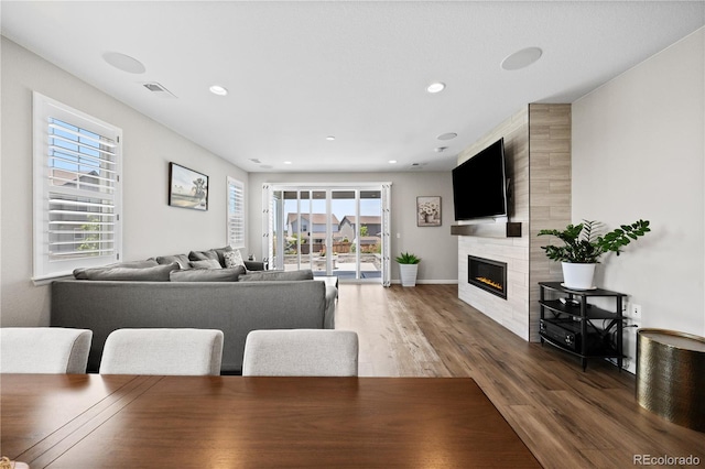 1925 Peregrine Dr, Brighton, CO 80601 - dining area with wood finished floors, a large fireplace, and recessed lighting