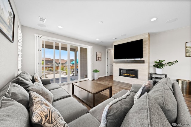 1925 Peregrine Dr, Brighton, CO 80601 - living area with wood finished floors, a fireplace, and recessed lighting