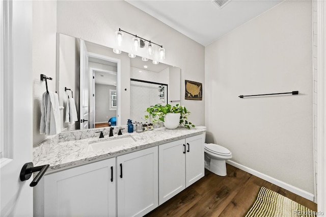 1925 Peregrine Dr, Brighton, CO 80601 - bathroom featuring vanity, wood finished floors, and an enclosed shower
