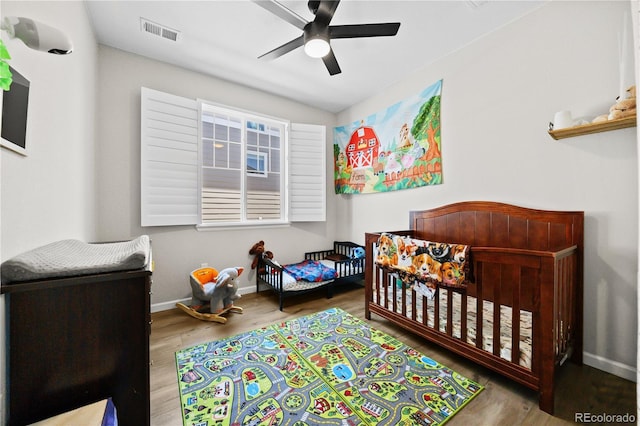 1925 Peregrine Dr, Brighton, CO 80601 - bedroom featuring wood finished floors, a crib, and ceiling fan