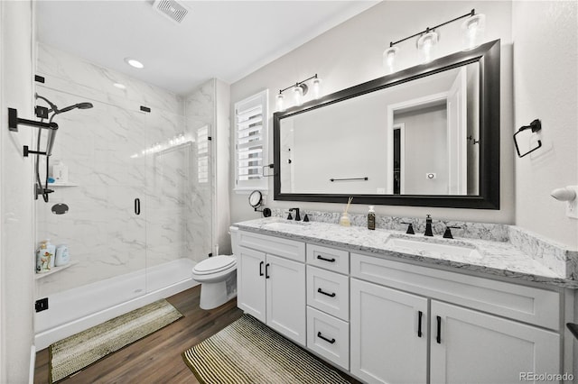 1925 Peregrine Dr, Brighton, CO 80601 - full bath featuring a marble finish shower, double vanity, and wood finished floors