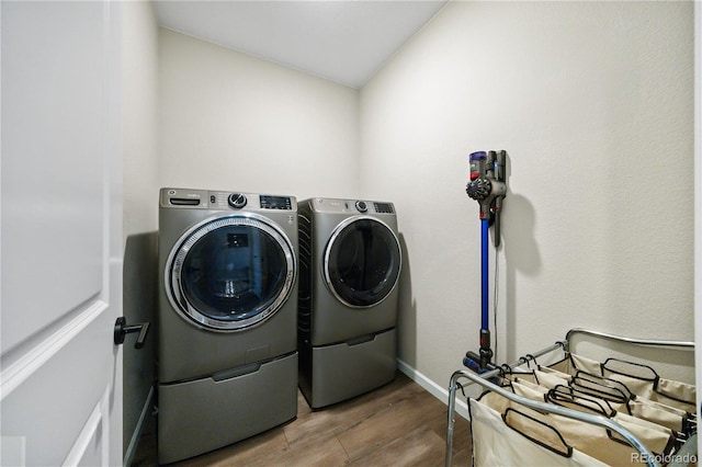 1925 Peregrine Dr, Brighton, CO 80601 - washroom with washing machine and clothes dryer and wood finished floors