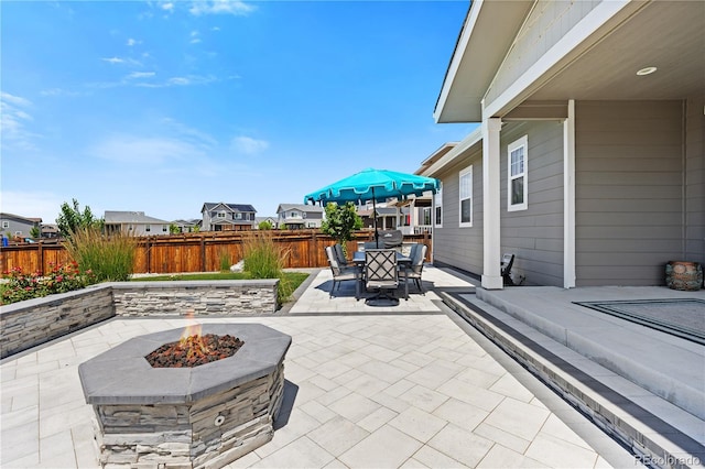 1925 Peregrine Dr, Brighton, CO 80601 - fenced backyard featuring a fire pit, a patio, outdoor dining area, and a residential view