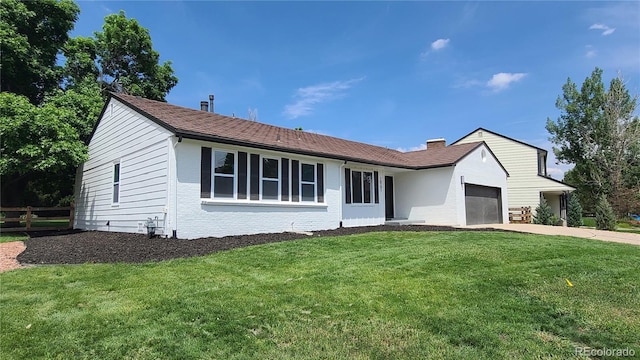 10297 W Crestone Mtn, Littleton, CO 80127 - ranch-style house featuring a garage, driveway, and a chimney