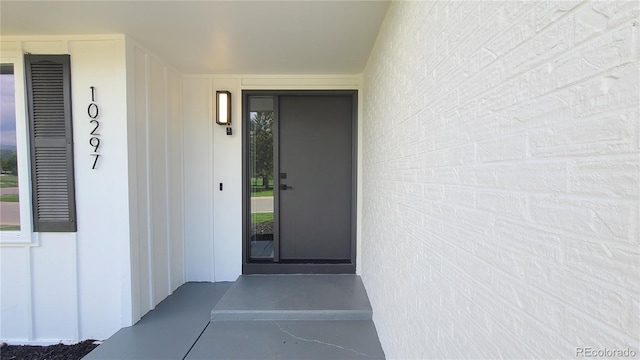 10297 W Crestone Mtn, Littleton, CO 80127 - doorway to property with board and batten siding
