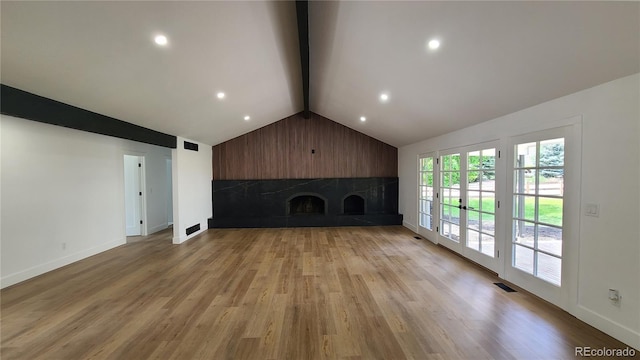 10297 W Crestone Mtn, Littleton, CO 80127 - unfurnished living room with a fireplace with raised hearth, light wood finished floors, baseboards, and recessed lighting