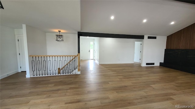 10297 W Crestone Mtn, Littleton, CO 80127 - unfurnished room with lofted ceiling, light wood-style flooring, baseboards, and recessed lighting