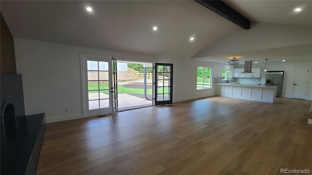 10297 W Crestone Mtn, Littleton, CO 80127 - unfurnished living room featuring beam ceiling, baseboards, a sink, light wood-style flooring, and recessed lighting