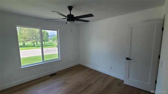 10297 W Crestone Mtn, Littleton, CO 80127 - empty room featuring wood finished floors, baseboards, and ceiling fan