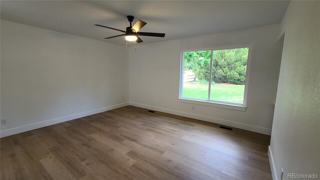 10297 W Crestone Mtn, Littleton, CO 80127 - empty room with baseboards, wood finished floors, and ceiling fan