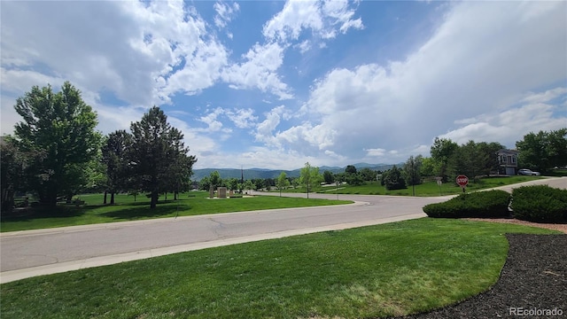 10297 W Crestone Mtn, Littleton, CO 80127 - view of asphalt street with a mountain view and traffic signs