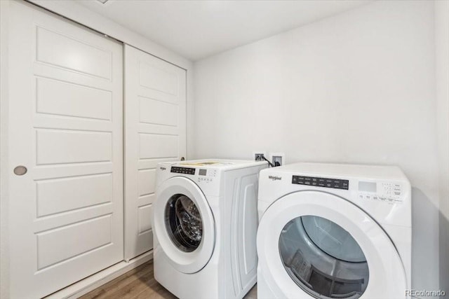 485 Interlocken Blvd Unit 209, Broomfield, CO 80021 - laundry area with washing machine and dryer and light wood-style flooring