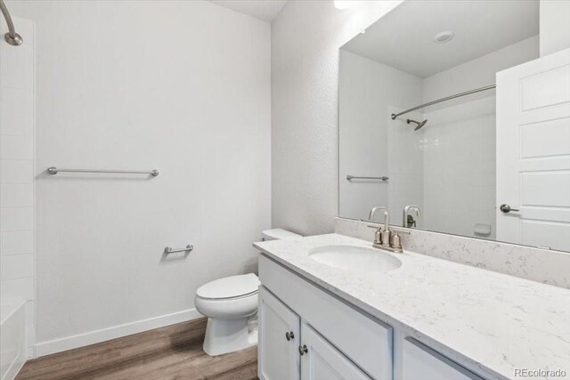 485 Interlocken Blvd Unit 209, Broomfield, CO 80021 - bathroom with wood finished floors, vanity, toilet, washtub / shower combination, and baseboards