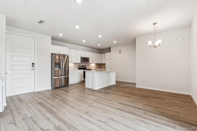 485 Interlocken Blvd Unit 209, Broomfield, CO 80021 - kitchen with appliances with stainless steel finishes, baseboards, a chandelier, recessed lighting, and light wood-style flooring