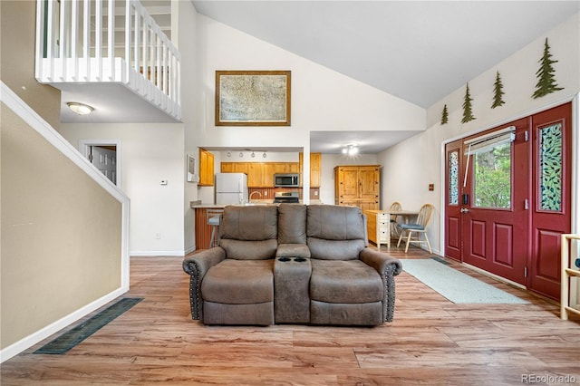 1777 Main St, Georgetown, CO 80444 - entryway featuring high vaulted ceiling, light wood-type flooring, baseboards, and stairway