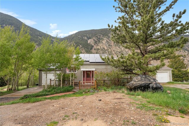 1777 Main St, Georgetown, CO 80444 - view of yard featuring a mountain view, an attached garage, and driveway