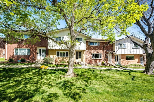 12632 W Virginia Ave, Lakewood, CO 80228 - view of property featuring brick siding and a front lawn