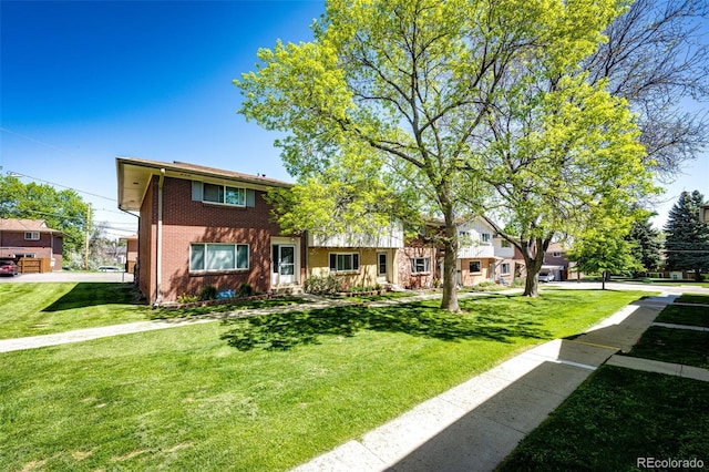 12632 W Virginia Ave, Lakewood, CO 80228 - view of front facade featuring a front lawn and brick siding
