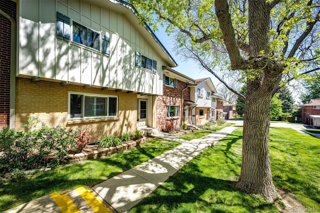 12632 W Virginia Ave, Lakewood, CO 80228 - view of side of property with brick siding, a lawn, and a residential view