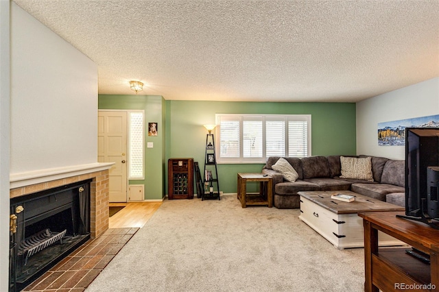 12632 W Virginia Ave, Lakewood, CO 80228 - living area featuring carpet, a tiled fireplace, and a textured ceiling