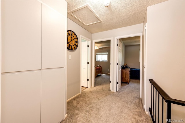 12632 W Virginia Ave, Lakewood, CO 80228 - corridor with attic access, light colored carpet, a textured ceiling, and baseboards