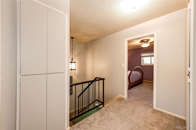 12632 W Virginia Ave, Lakewood, CO 80228 - corridor with an upstairs landing, carpet, a textured ceiling, and baseboards