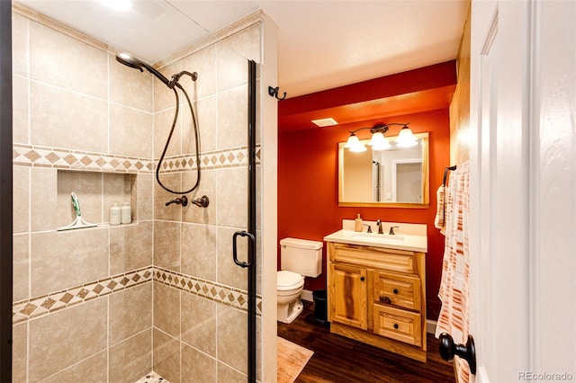 12632 W Virginia Ave, Lakewood, CO 80228 - bathroom with a shower stall, toilet, wood finished floors, and vanity