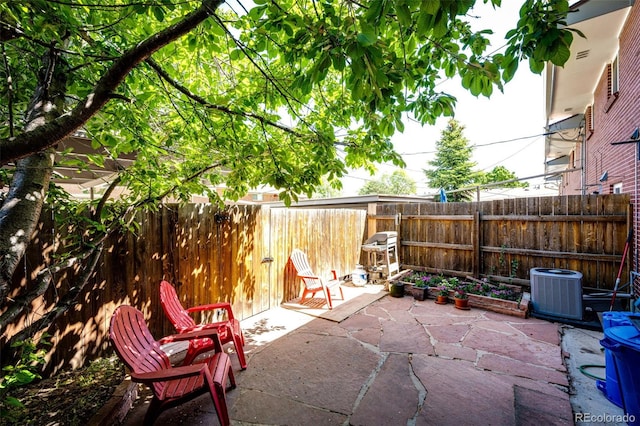 12632 W Virginia Ave, Lakewood, CO 80228 - view of patio / terrace featuring a fenced backyard and cooling unit