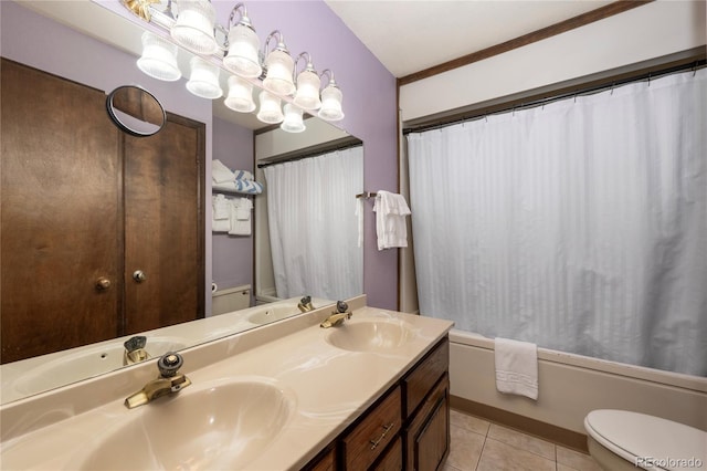 full bathroom with toilet, a sink, and tile patterned floors