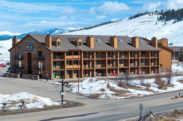 snow covered property featuring a mountain view