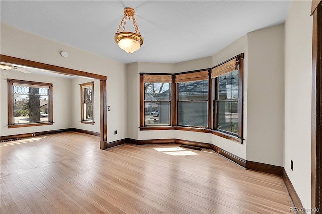 unfurnished room featuring light wood finished floors and baseboards