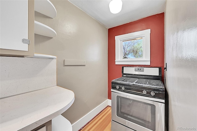 bathroom with wood finished floors and baseboards