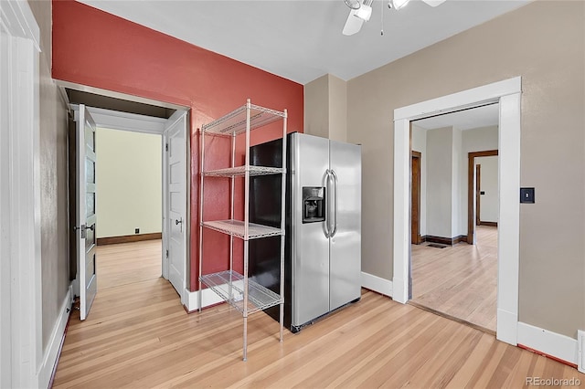 kitchen featuring ceiling fan, baseboards, light wood-style floors, and stainless steel fridge