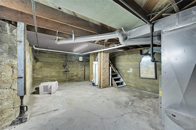 unfinished below grade area featuring water heater