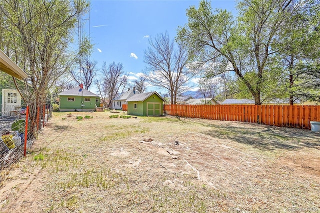 view of yard with an outdoor structure, fence private yard, and a shed