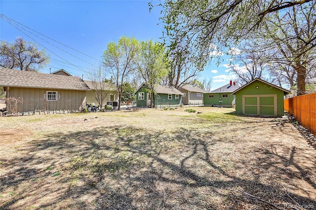 view of yard featuring an outdoor structure and fence