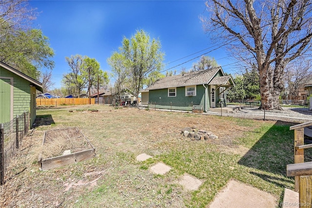 view of yard featuring a fenced backyard and a garden