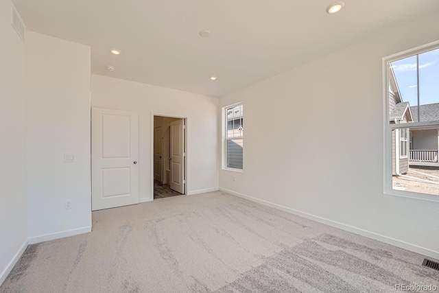 unfurnished room with light colored carpet