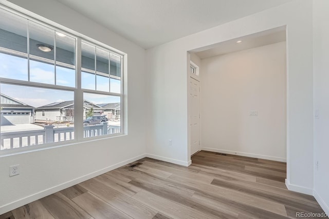 spare room with light wood-type flooring