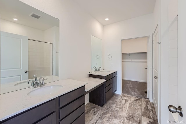 bathroom with vanity and a shower with door