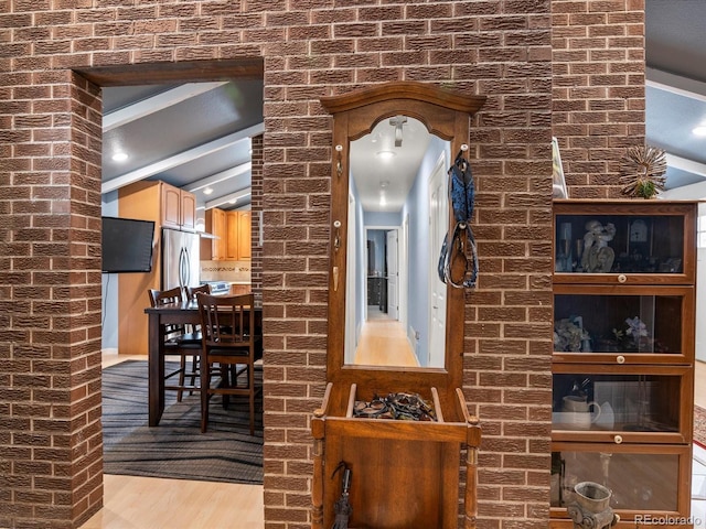 details featuring stainless steel fridge and hardwood / wood-style floors